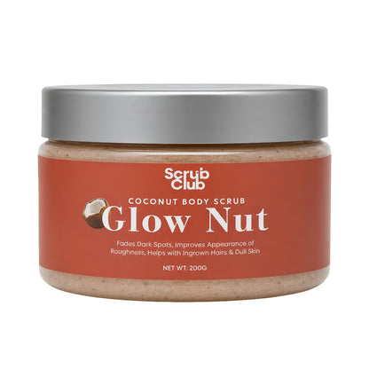 A jar of Scrub Club Coconut Body Scrub in the Glow Nut scent, featuring a terracotta-colored label and a metallic silver lid, set against a plain white background.