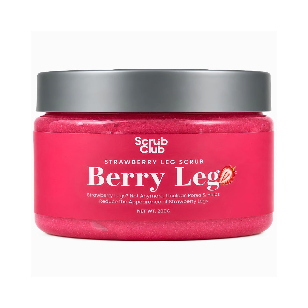 A jar of Scrub Club Berry Leg Strawberry Leg Scrub, featuring a vibrant pink scrub visible through the clear container, a dark gray lid, and a white label with red and black text.
