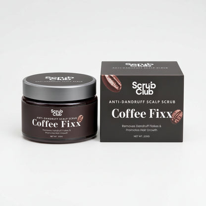 A dark brown jar of Scrub Club Coffee Fixx Scalp Scrub next to its dark gray packaging box, both featuring coffee bean graphics and white text on a clean white background.